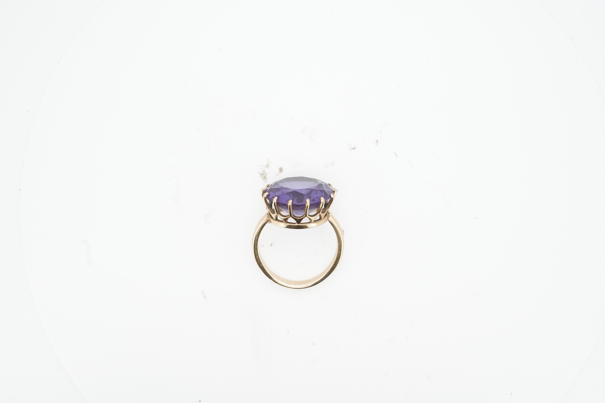 A synthetic colour-change sapphire ring, claw-set with a circular-cut synthetic colour-change sapphire measuring approximately 15 x 15 x 7.9mm, mounted in gold, size H1/2